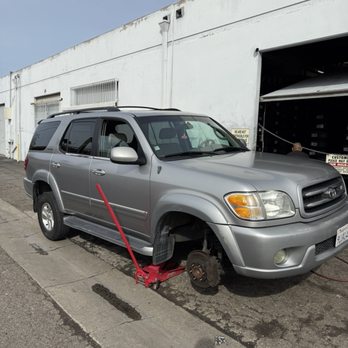 SUV lifted on a jack during tire service at Junior's Tires & Wheels